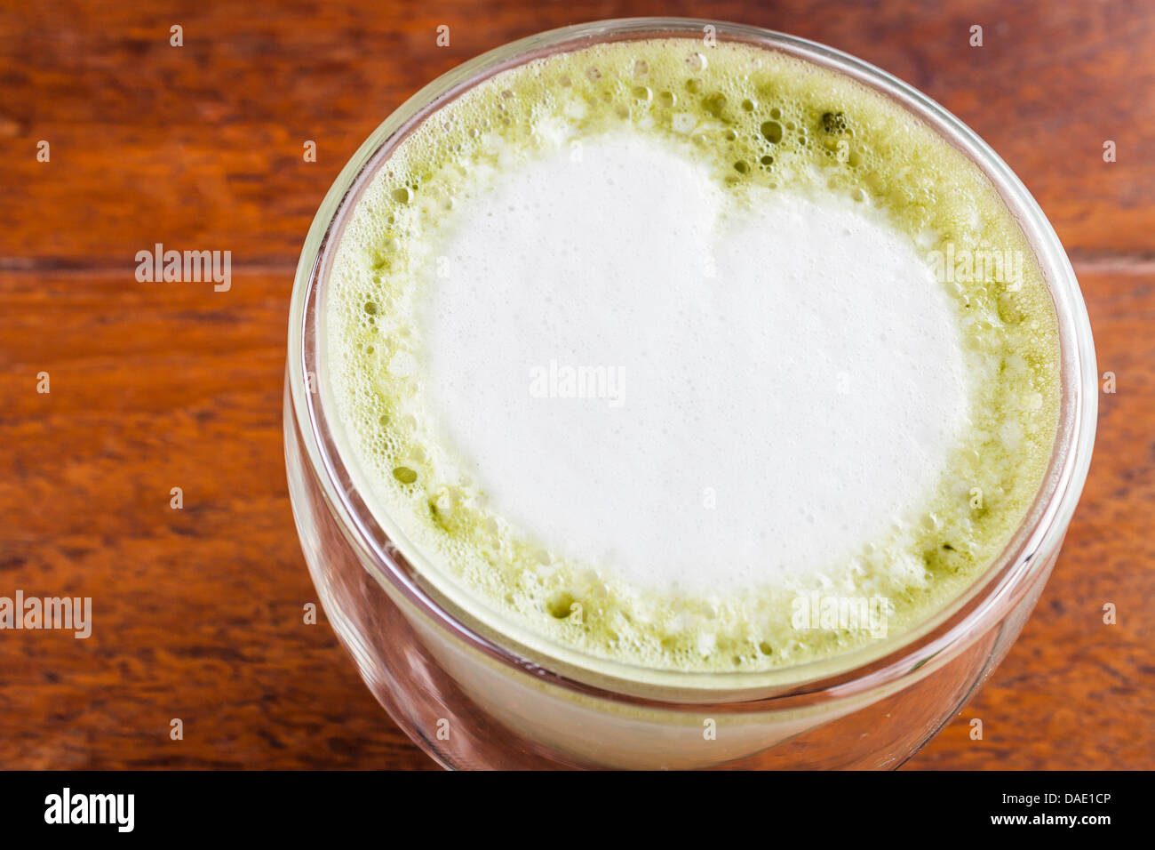 Matcha green tea latte serving on wood table Stock Photo