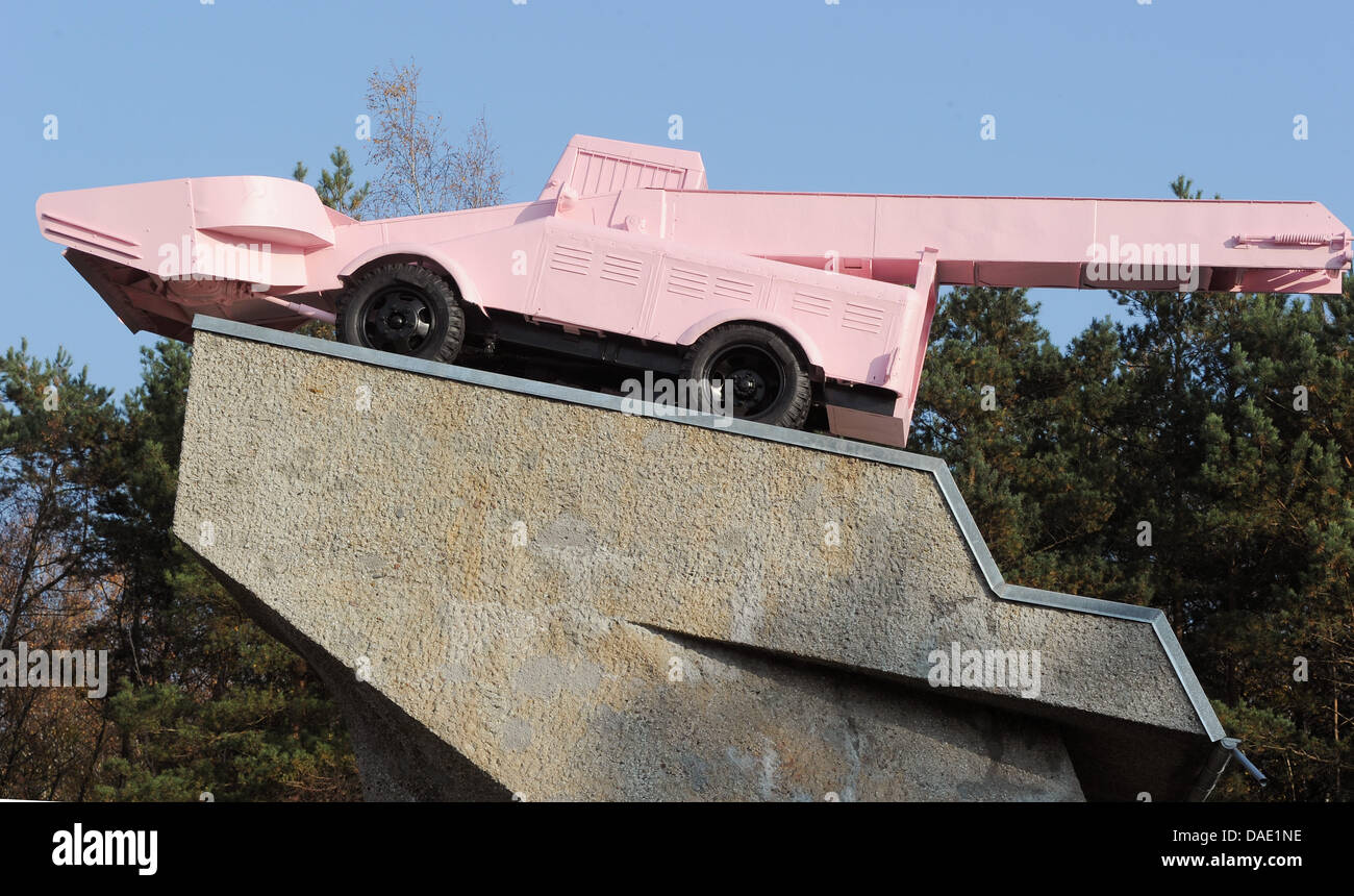 The pink snow plough is refurbished at the highway A115 across former German-German checkpoint Drei Linden in Kleinmachnow, Germany, 08 November 2011. In 1993, it had been installed by artist Eckhart Haisch and replaced a T 34 tank. The tank was set up as a memorial for the unity of the 1st Ukranian and 1st Belarussian front for the fight over Berlin in April 1945. The refurbishing Stock Photo