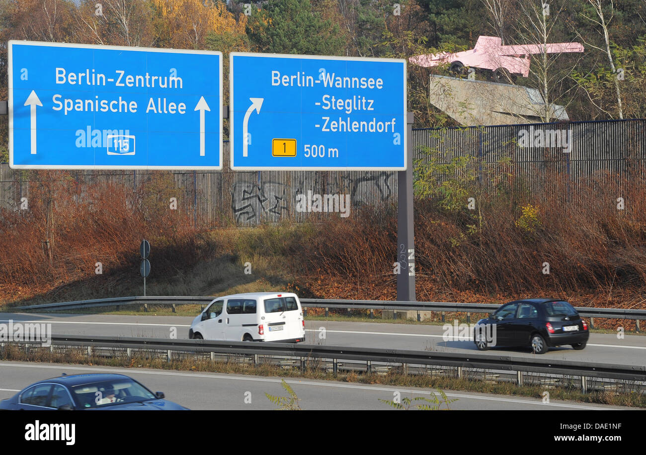 The pink snow plough (TOP R) is refurbished at the highway A115 across former German-German checkpoint Drei Linden in Kleinmachnow, Germany, 08 November 2011. In 1993, it had been installed by artist Eckhart Haisch and replaced a T 34 tank. The tank was set up as a memorial for the unity of the 1st Ukranian and 1st Belarussian front for the fight over Berlin in April 1945. The refu Stock Photo