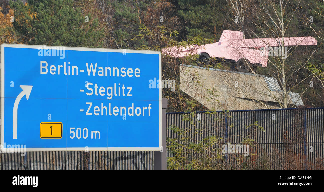 The pink snow plough (TOP R) is refurbished at the highway A115 across former German-German checkpoint Drei Linden in Kleinmachnow, Germany, 08 November 2011. In 1993, it had been installed by artist Eckhart Haisch and replaced a T 34 tank. The tank was set up as a memorial for the unity of the 1st Ukranian and 1st Belarussian front for the fight over Berlin in April 1945. The refu Stock Photo
