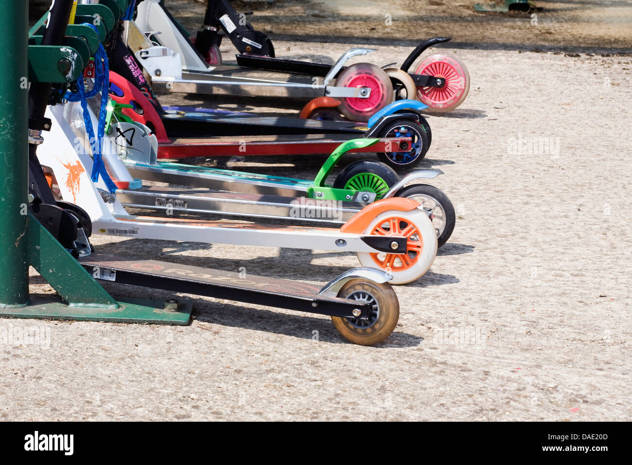Children's scooters lined up at school. Stock Photo