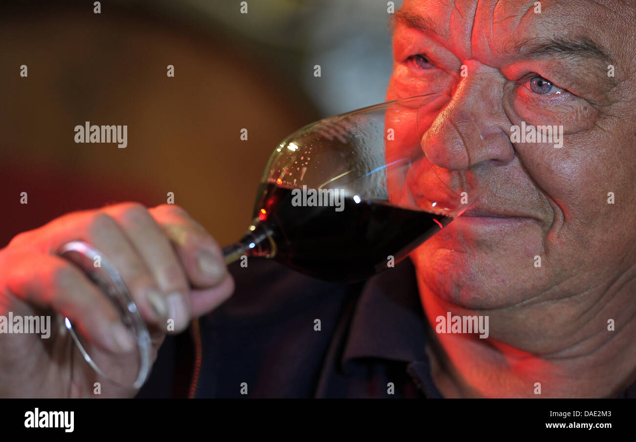 German winegrower Manfred Schmitt takes a sip of wine during a wine