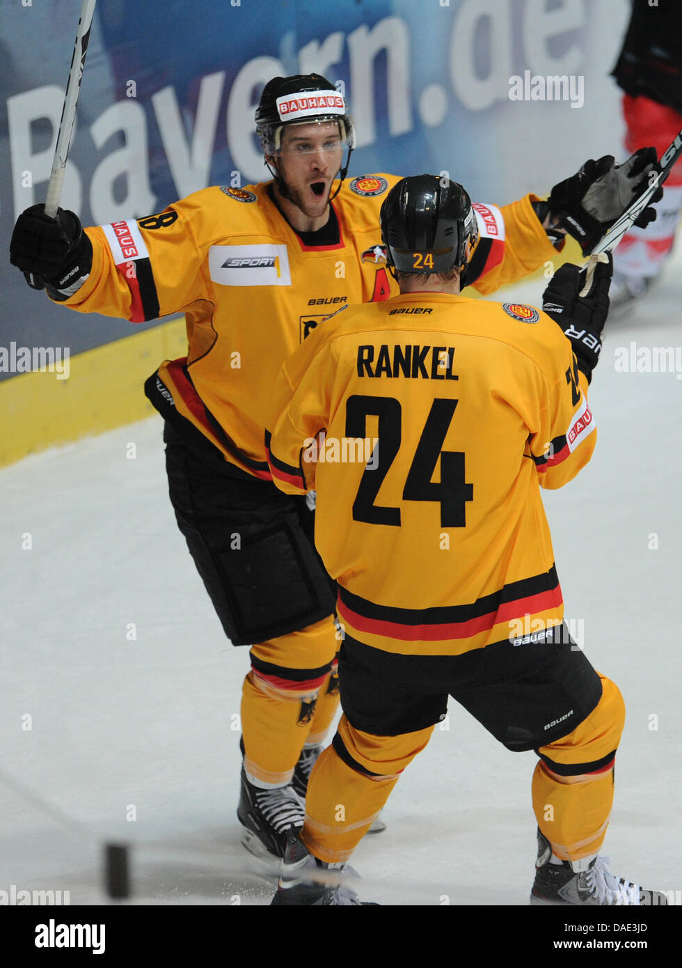 German ice hockey players Kai Hospelt (L) and his teammate and goal