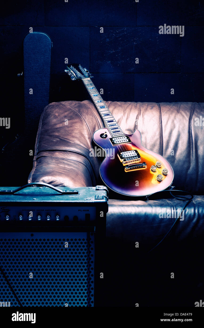 Electric guitar with amplifier on sofa Stock Photo Alamy