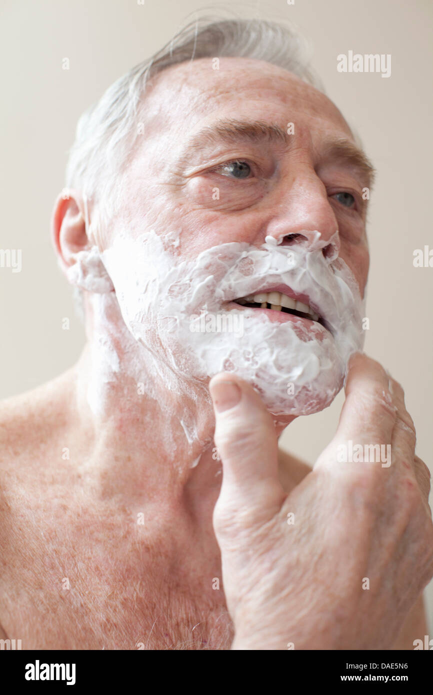 Senior man applying shaving cream Stock Photo