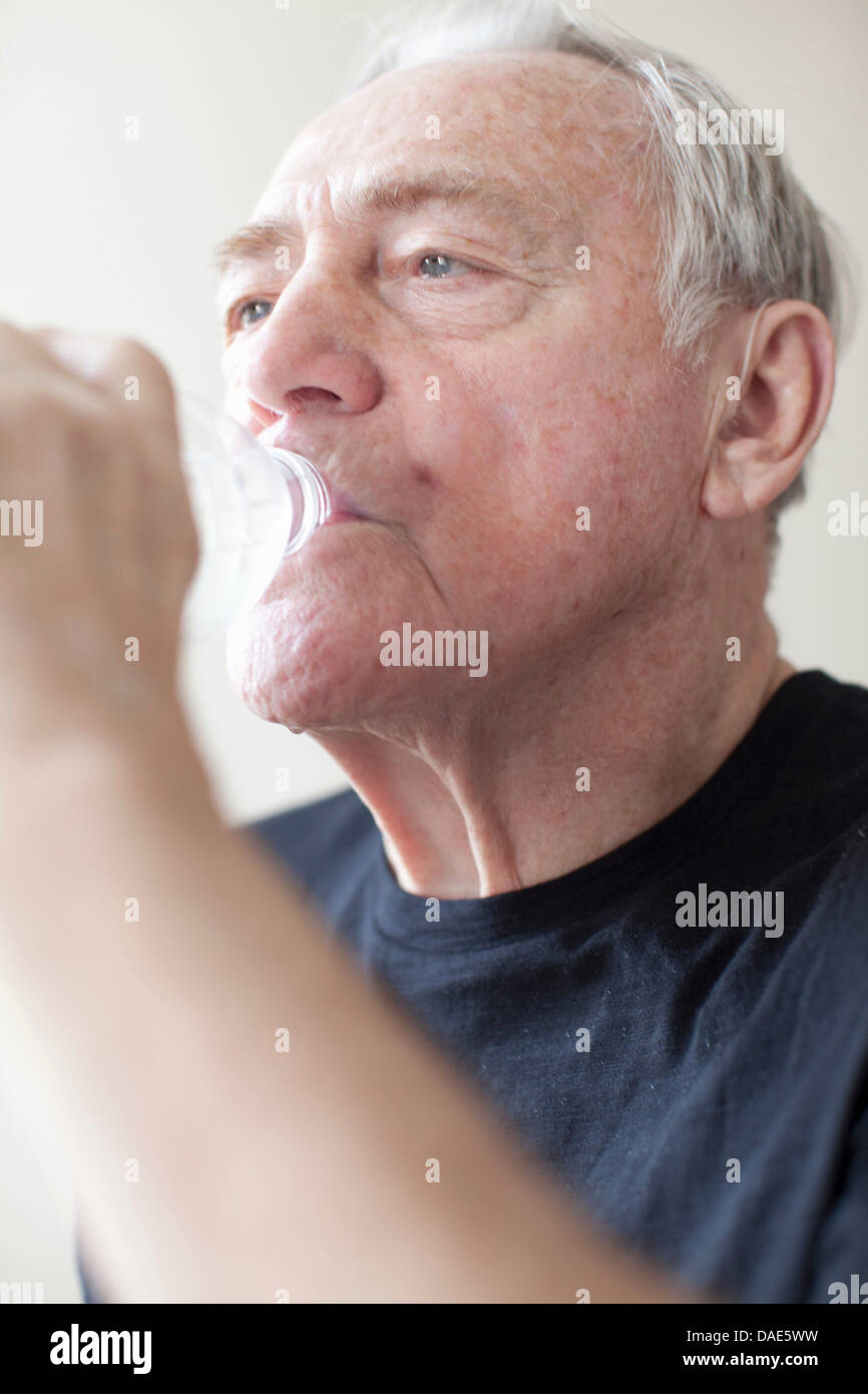 Senior man drinking mineral water Stock Photo