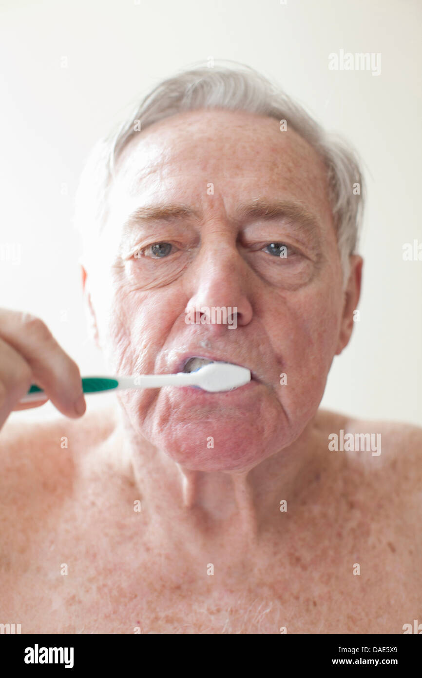 Senior man brushing teeth Stock Photo