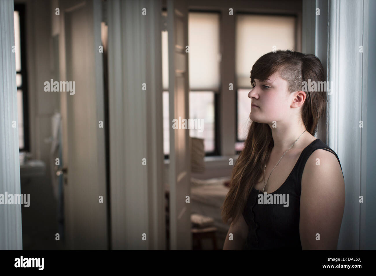 Young woman in doorway Stock Photo - Alamy