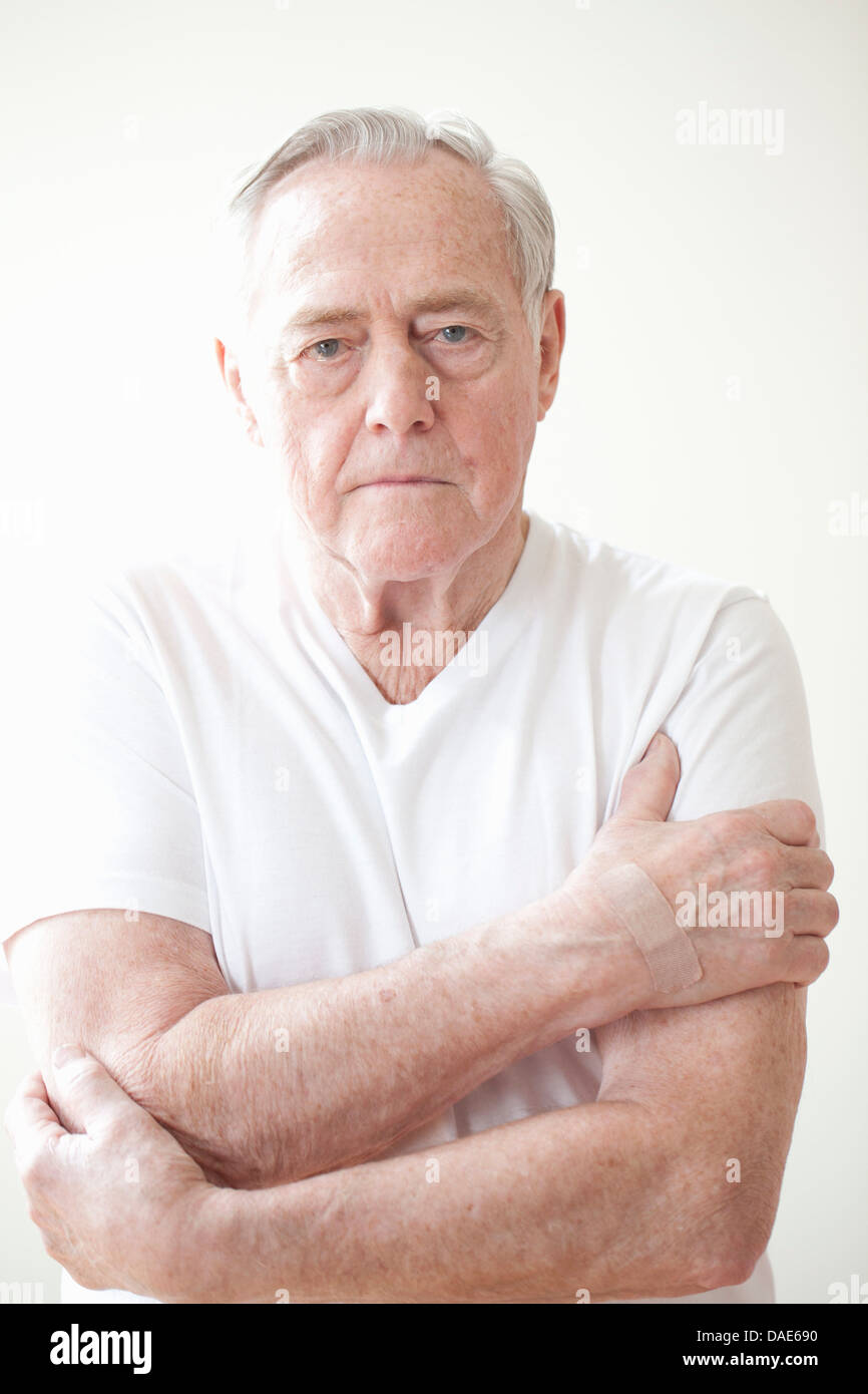 Portrait of senior man wearing white t shirt Stock Photo