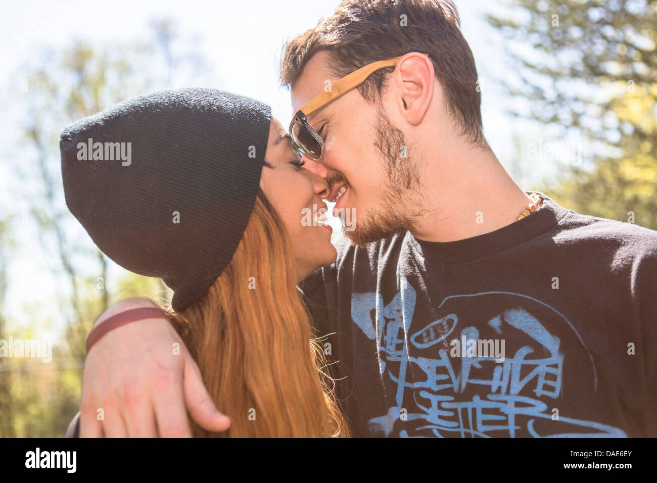 RFDAE6EY–Couple. kissing, woman wearing knit hat. 