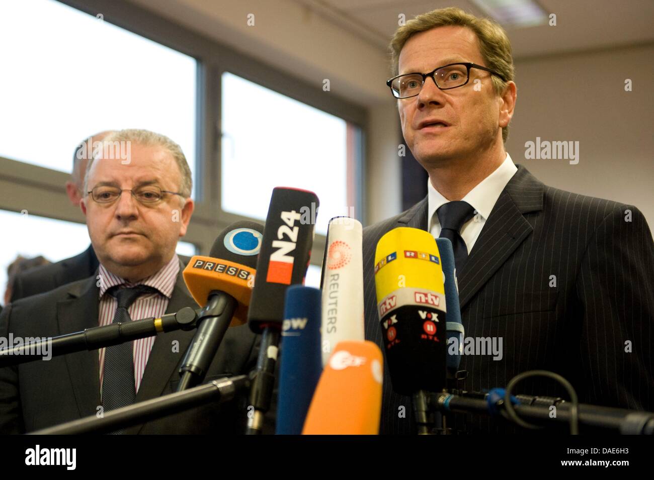 German Foreign Minister Guido Westerwelle and Kenan Kolat (L), Chairman of the Turkish Community in Germany, answer journalists' questions in the headquarters of the Turkish Community in Germany in Berlin, Germany, 15 November 2011. The reason for the visit is the newest information about the right-wing motivated murders of foreign fellow citizens. Photo: SEBASTIAN KAHNERT Stock Photo
