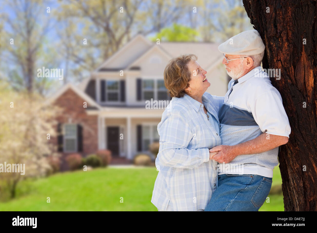 Happy Senior Couple in the Front Yard of Their House Stock Photo - Alamy