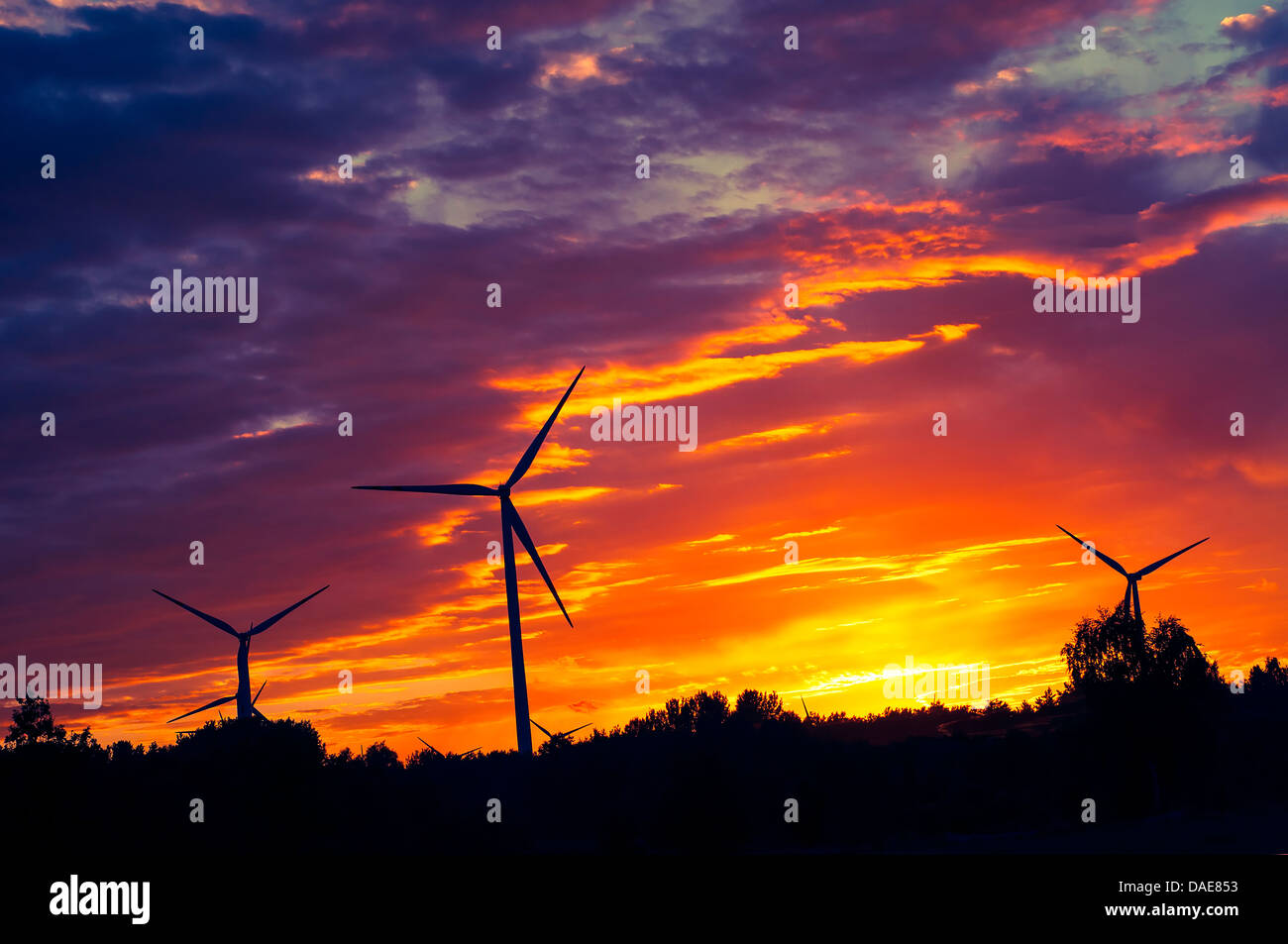 A silhouette of windturbines on a amazing sunset Stock Photo - Alamy