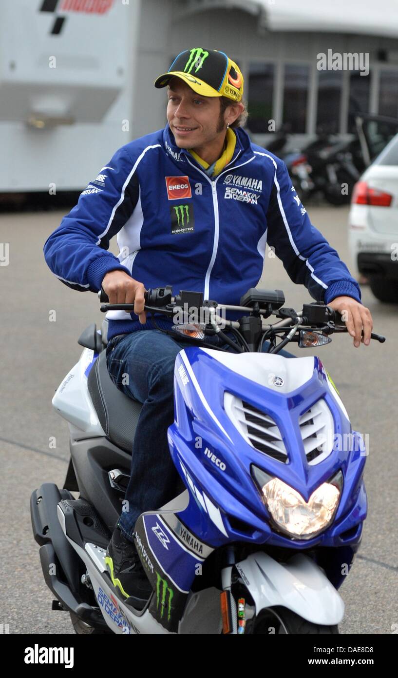 Italian Yamaha driver Valentino Rossi rides onto the grounds of the  Sachsenring on his moped in Hobenstein-Ernstthal, Germany, 11 July 2013.  The German Grand Prix in the classes Moto3, Moto2 and MotoGP