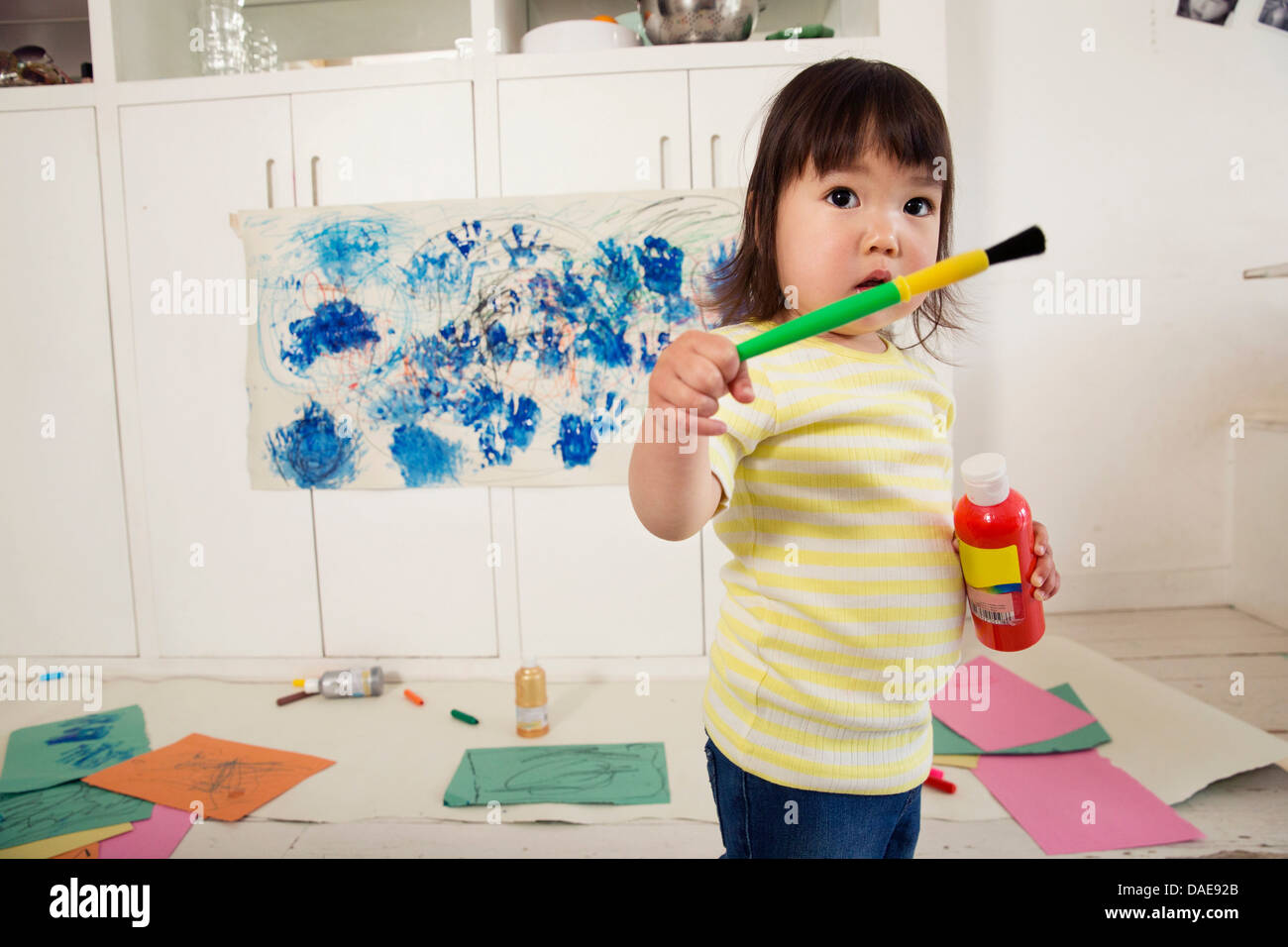 Girl holding paint brush hi-res stock photography and images - Alamy