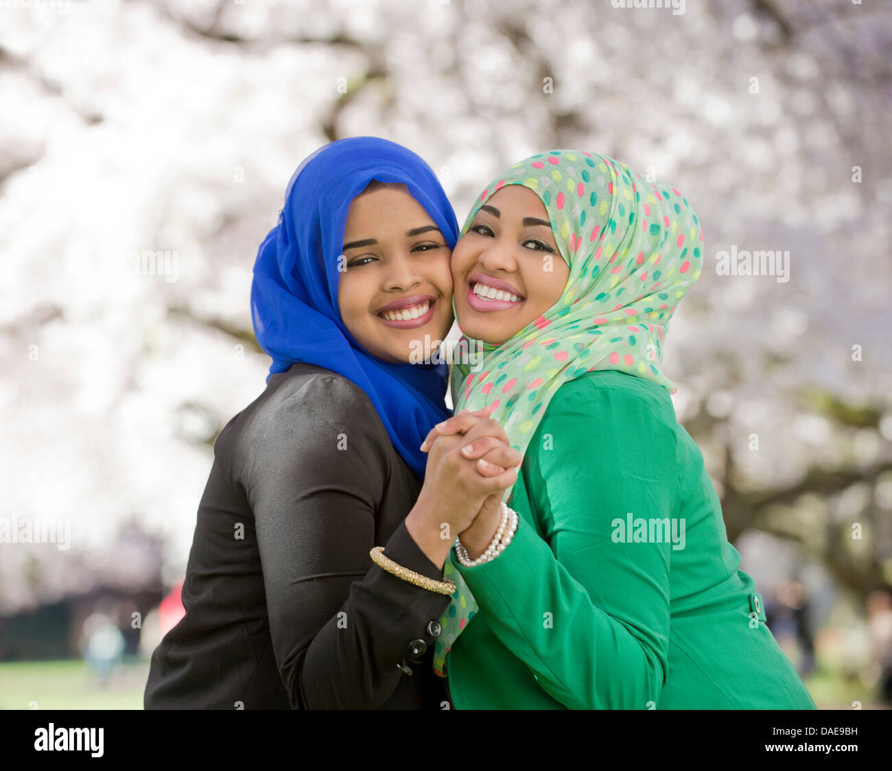 Portrait of two young females in park dancing together Stock Photo