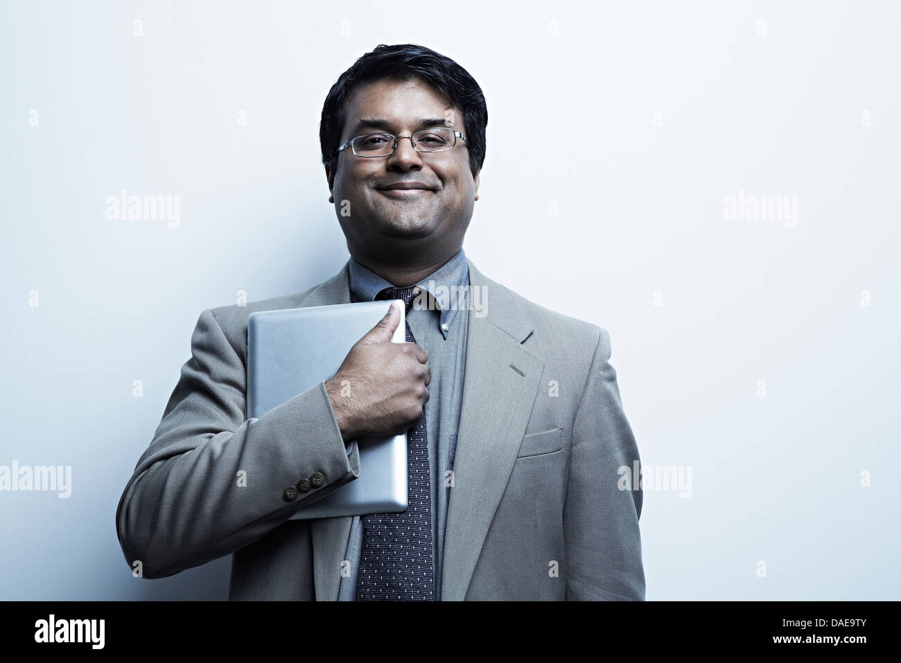 Studio portrait of businessman holding digital tablet Stock Photo