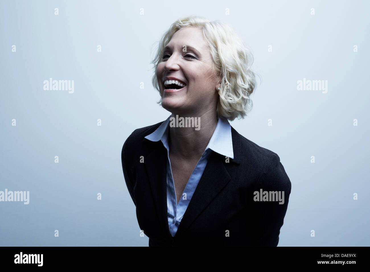 Studio portrait of businesswoman laughing Stock Photo