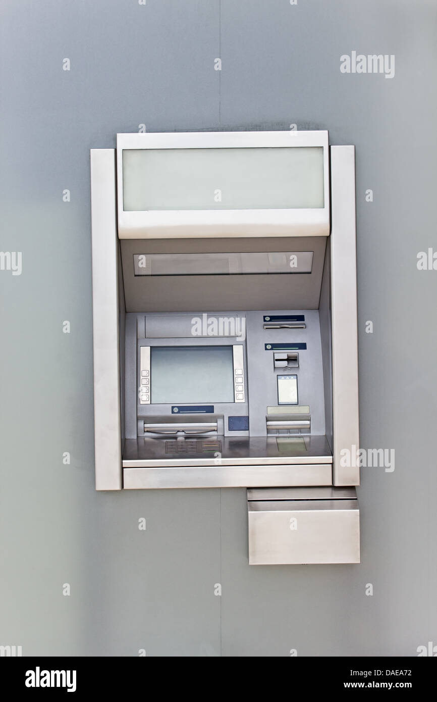 Cash dispense on metallic wall Stock Photo