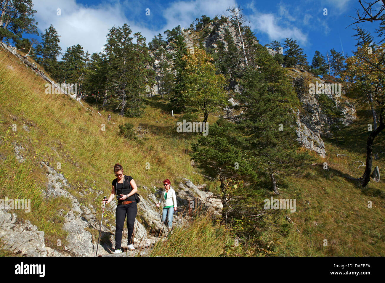 two women descending from Tegelberg, Germany, Bavaria, Allgaeu, Schwangau Stock Photo