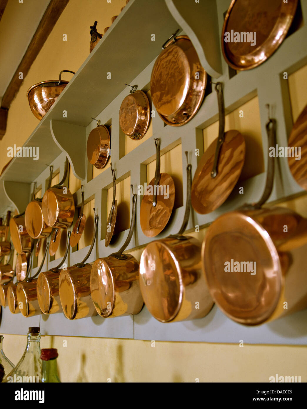 Rows of copper pots and pans hanging on wall Stock Photo Alamy