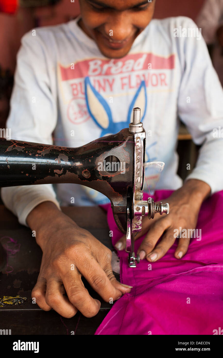 A man uses a sewing machine for making Jamdani sari in Mirpur Benarashi Palli, Dhaka, Bangladesh