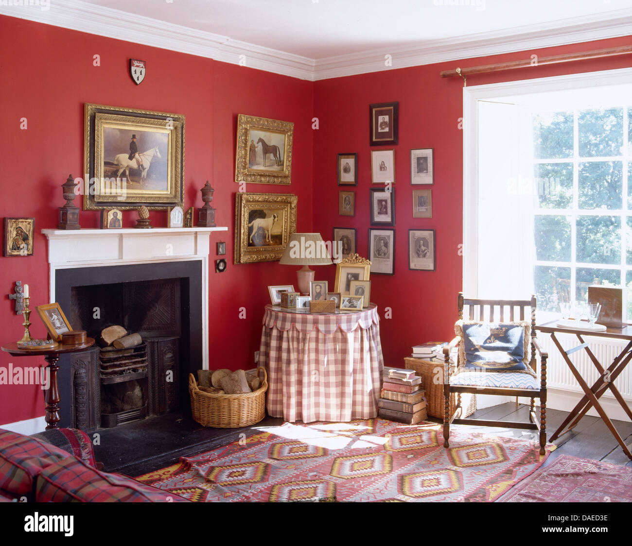 Checked cloth on small circular table beside fireplace in corner of red