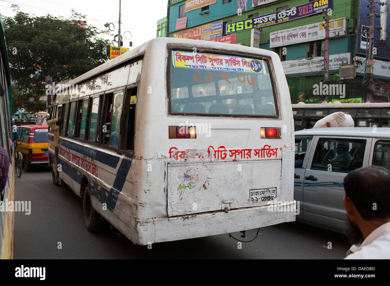 A beaten and battered public bus crawls through a traffic jam on a normal day in the center of Dhaka, Bangladesh Stock Photo