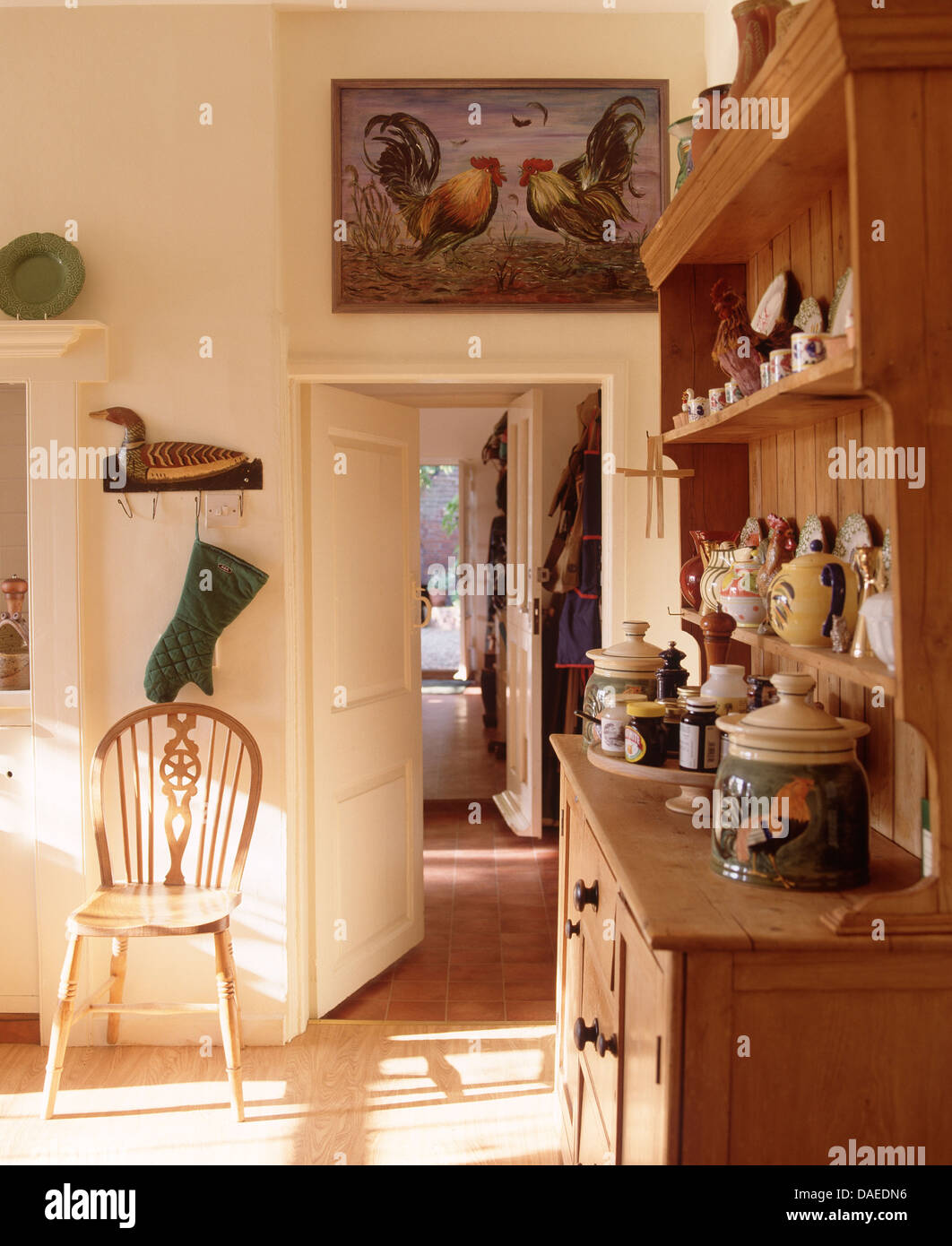 Display Of Pottery On Small Pine Dresser In Country Dining Room