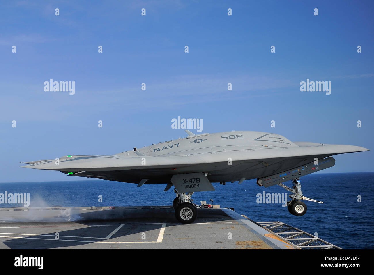 A US Navy X-47B unmanned combat air system drone launches from the flight deck of the aircraft carrier USS George H.W. Bush July 10, 2013 operating in the Atlantic Ocean. The landing marked the first time an unmanned aircraft completed an arrested landing at sea. Stock Photo