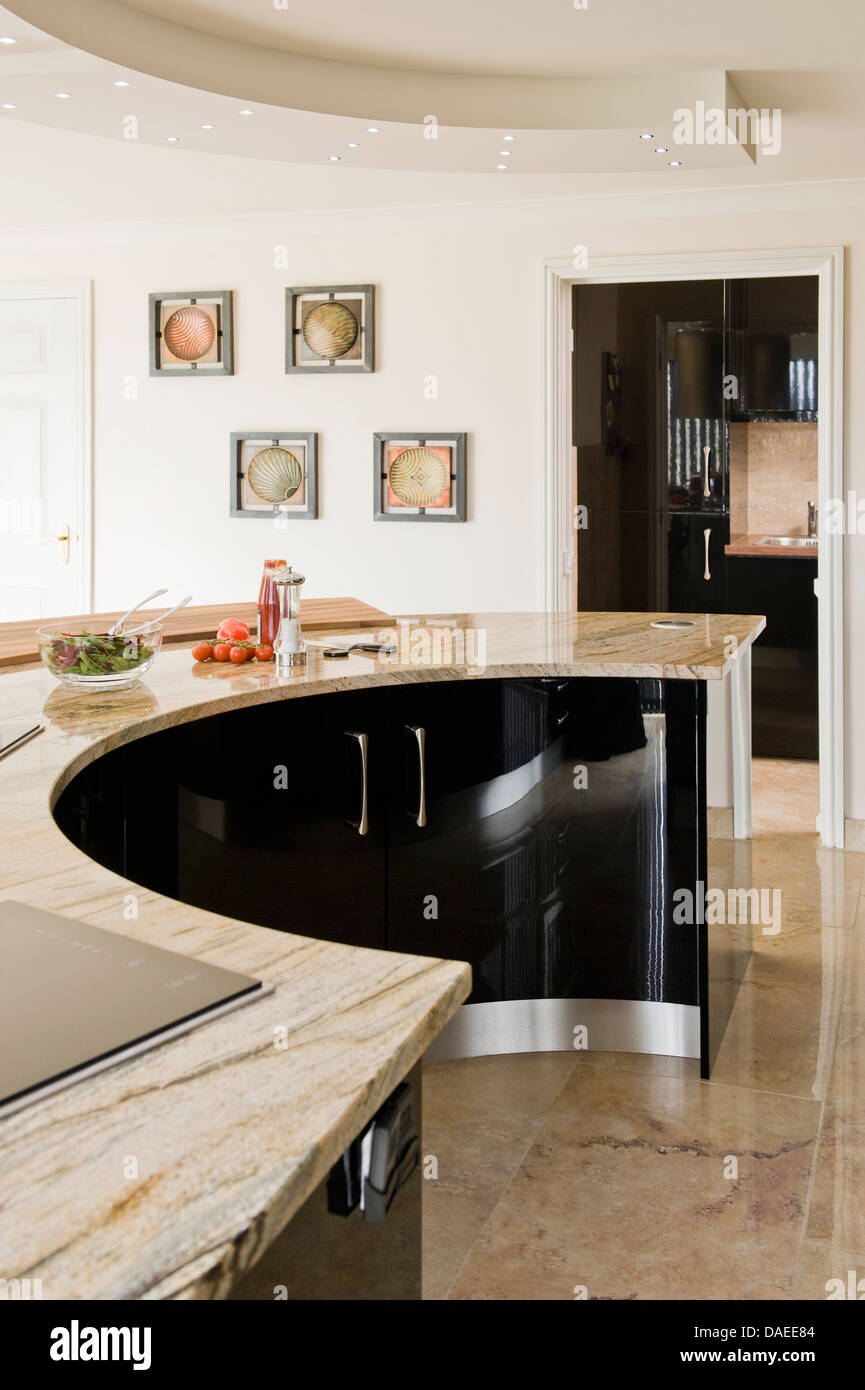 Curved black central island unit in modern kitchen Stock Photo