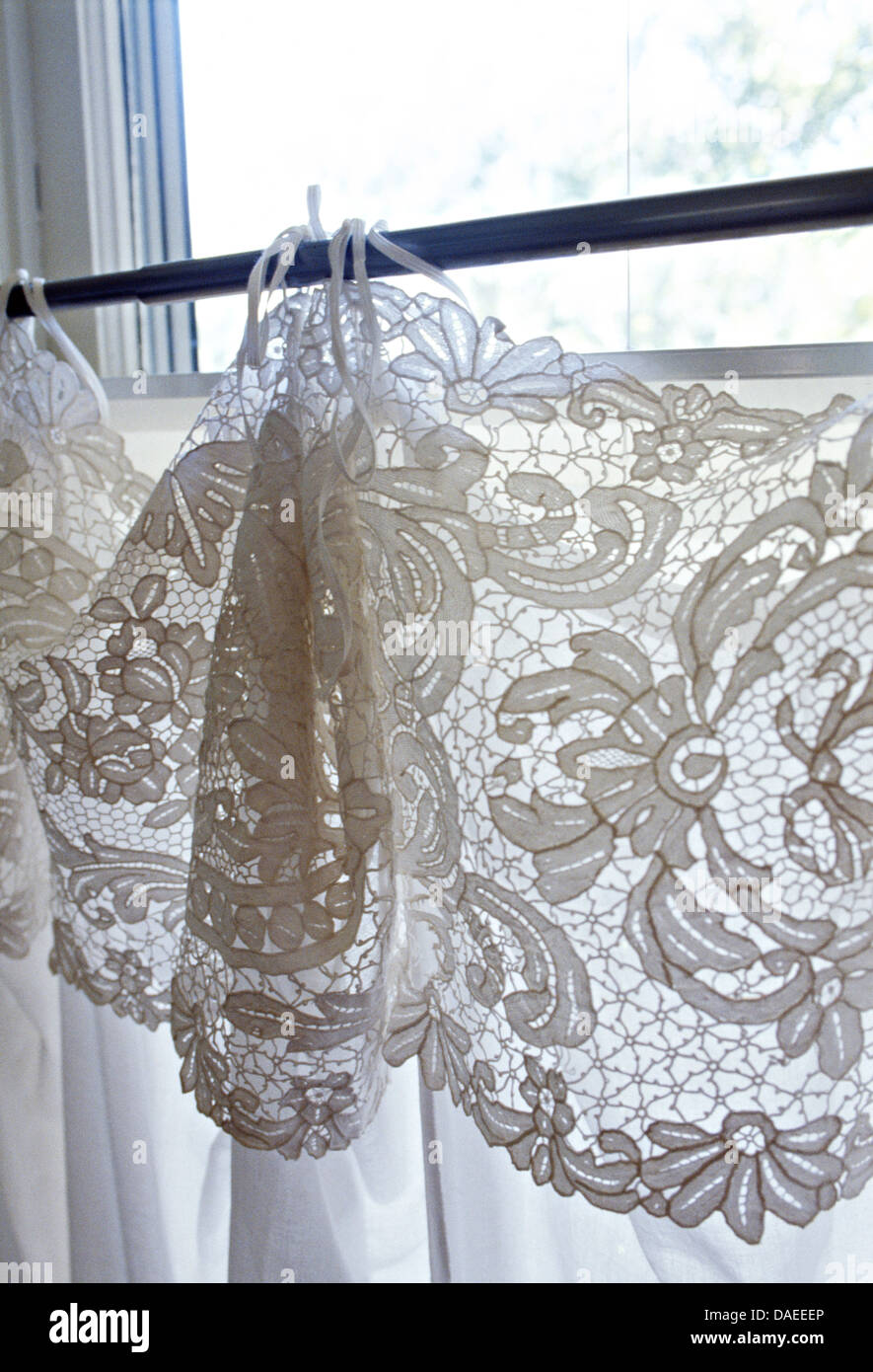 Close Up Of Window With White Lace Trim On White Cotton Curtains