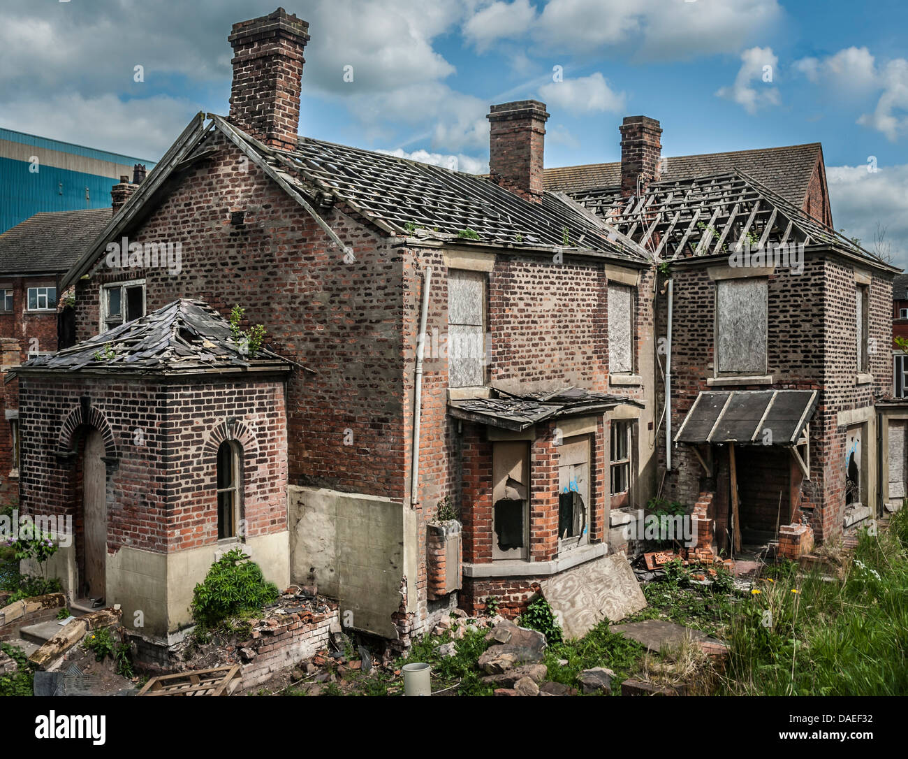 Abandoned and boarded up old house with missing roof tiles along Chapel