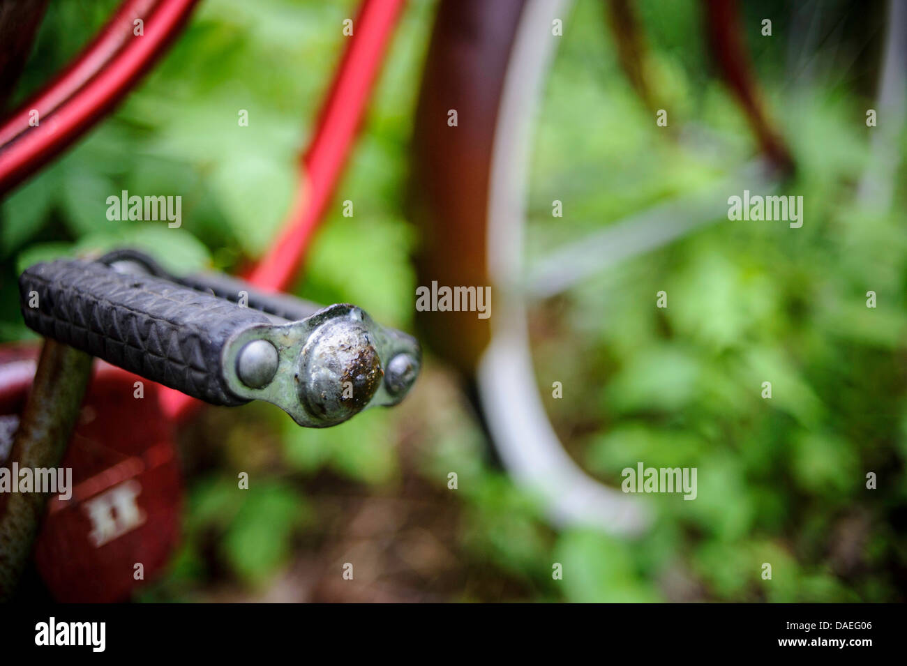close up of old red bicycle against green background Stock Photo Alamy