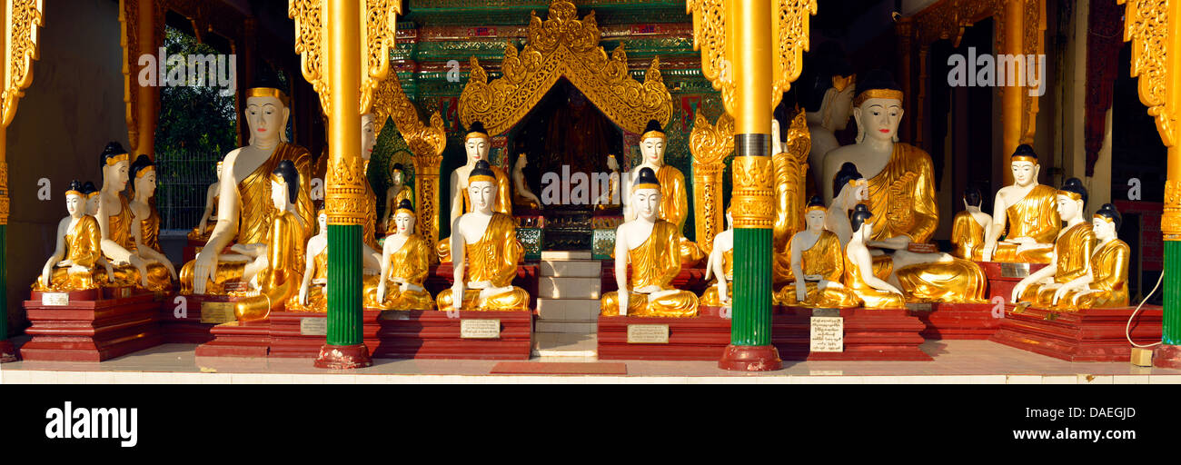 a great number of Buddha statues at the Shwedagon Pagoda, the most important sacral building and religious centre of the country, Burma, Yangon Stock Photo