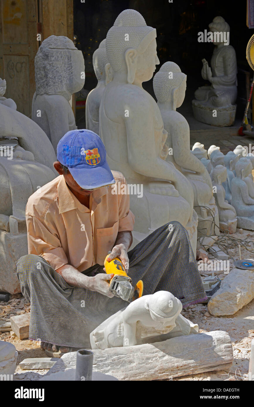 man with a stonecutter working on a Buddha sculpture, Burma, Mandalay Stock Photo