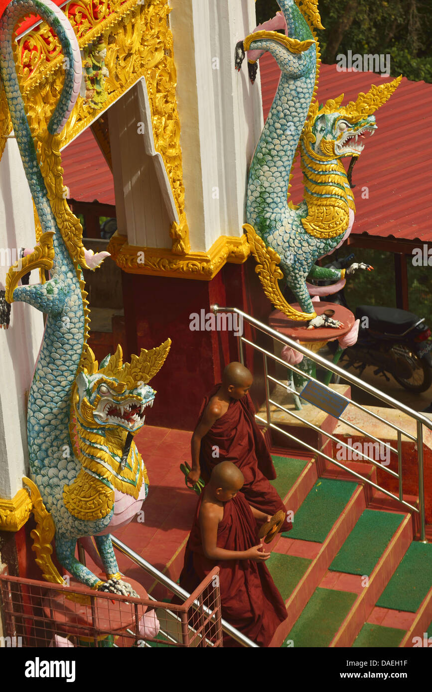 two young monks leaving the pagoda, Burma, Pindaya Stock Photo