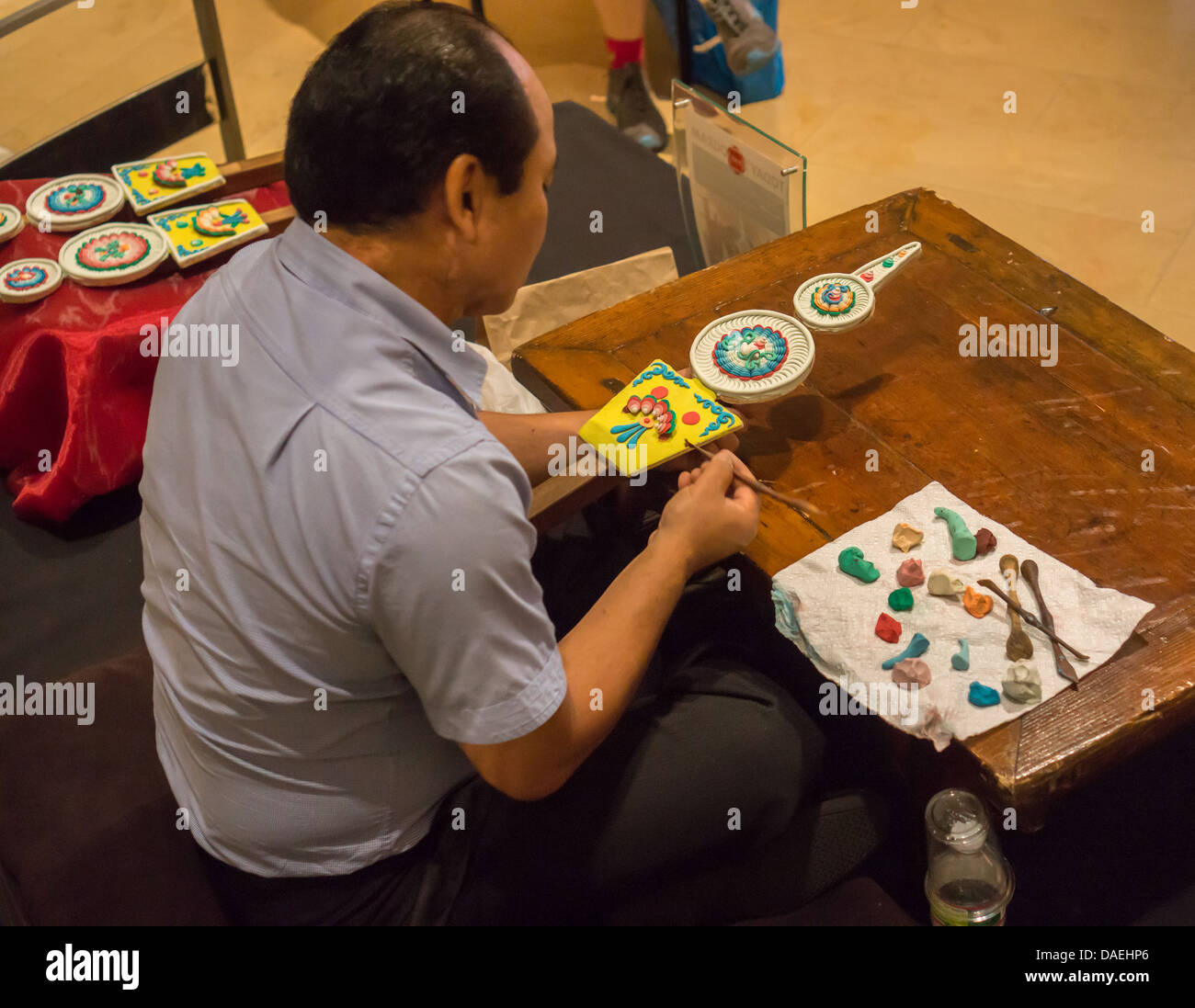 Tibetan tormas, or butter sculptures, being made at an exhibition in New York Stock Photo