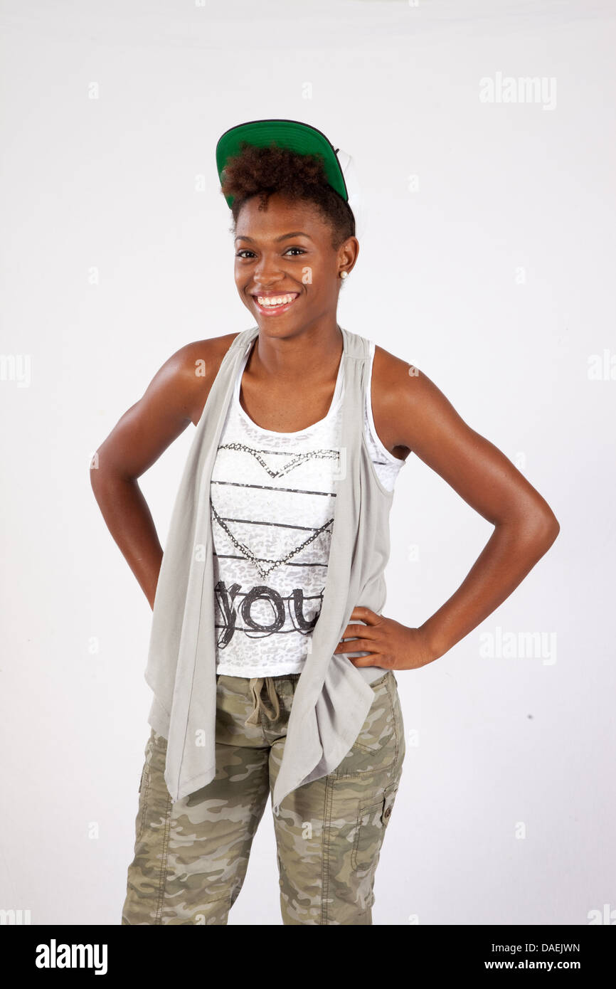 Cute black woman standing and looking at the camera with a friendly ...