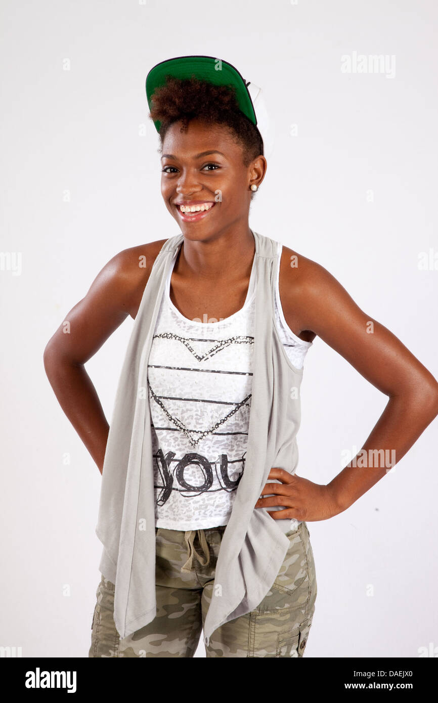 Cute black woman standing and looking at the camera with a friendly ...