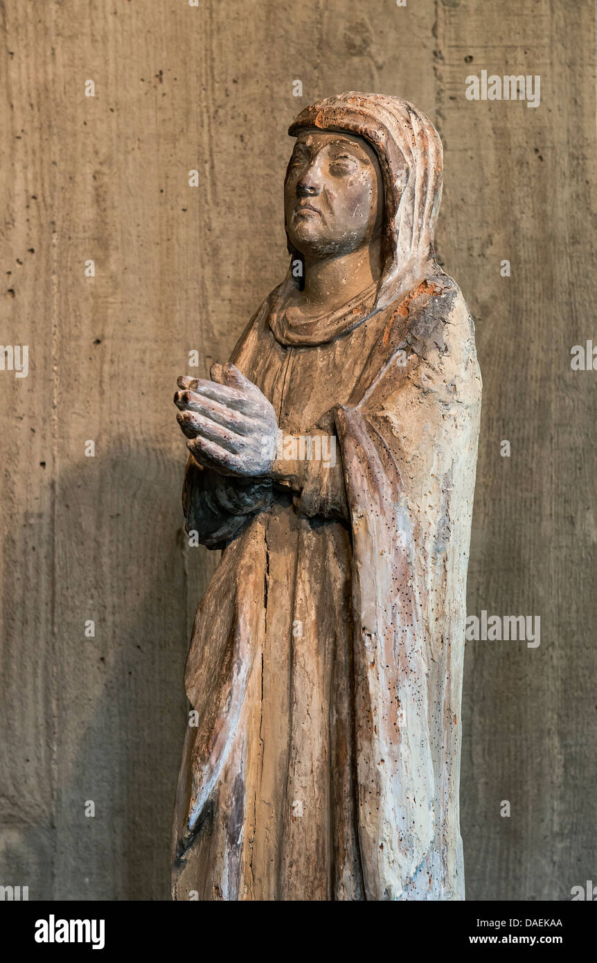 Ancient christian religious sculpture of a prayerful believer. Stock Photo