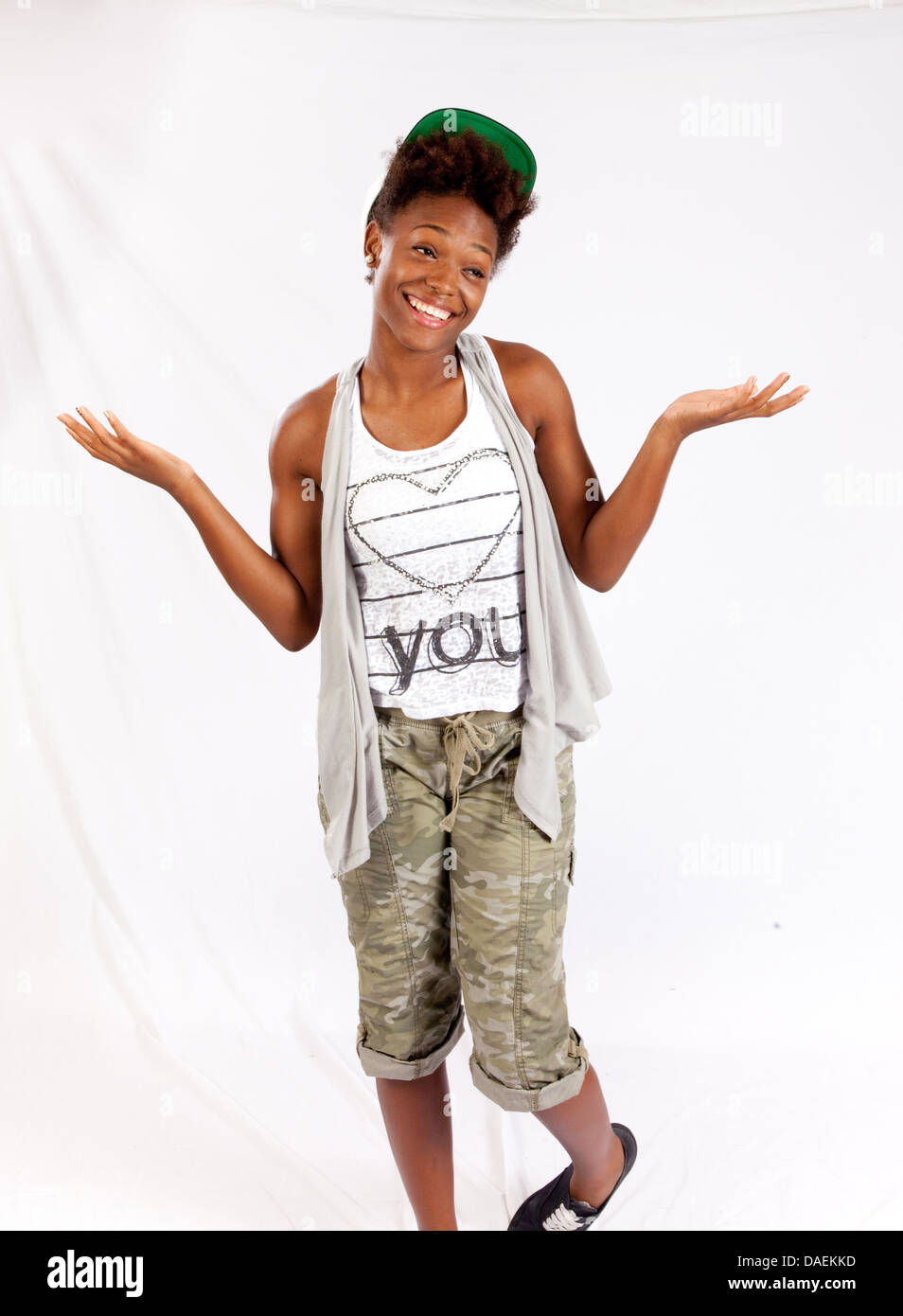 Black woman standing looking at the camera with a friendly, happy laugh ...