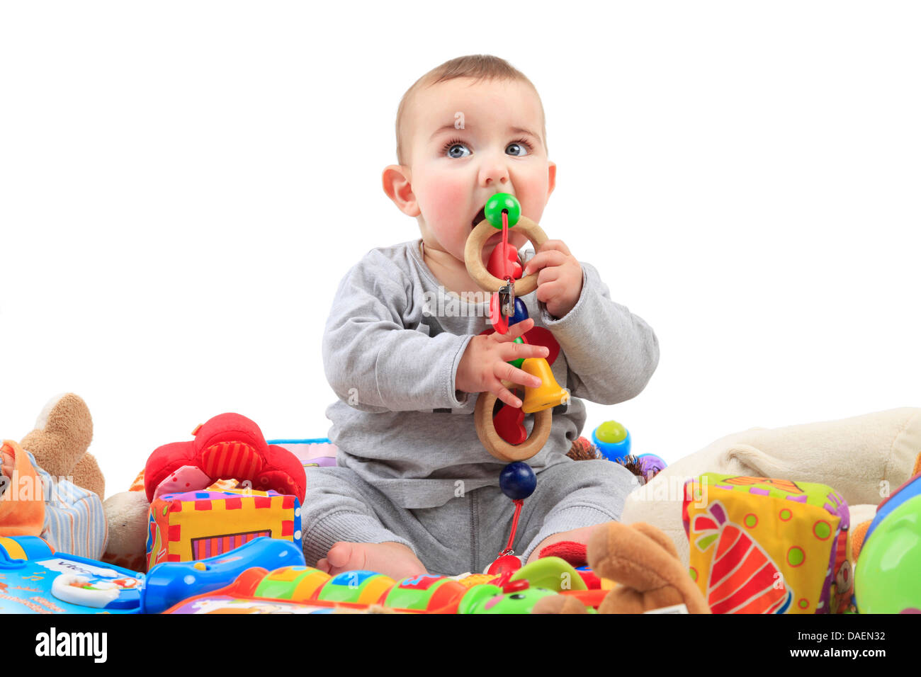 lively baby sitting in playthings and uttering something of  it Stock Photo
