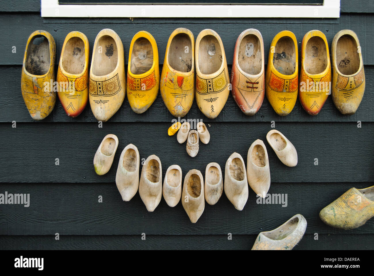 Used Dutch clogs or klompen were used to decorate a house wall. Stock Photo