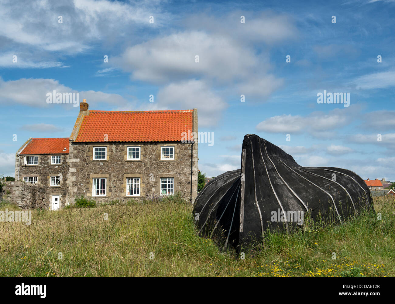 Old Herring boat shed and house in the harbour at Lindisfarne, Northumberland, England Stock Photo