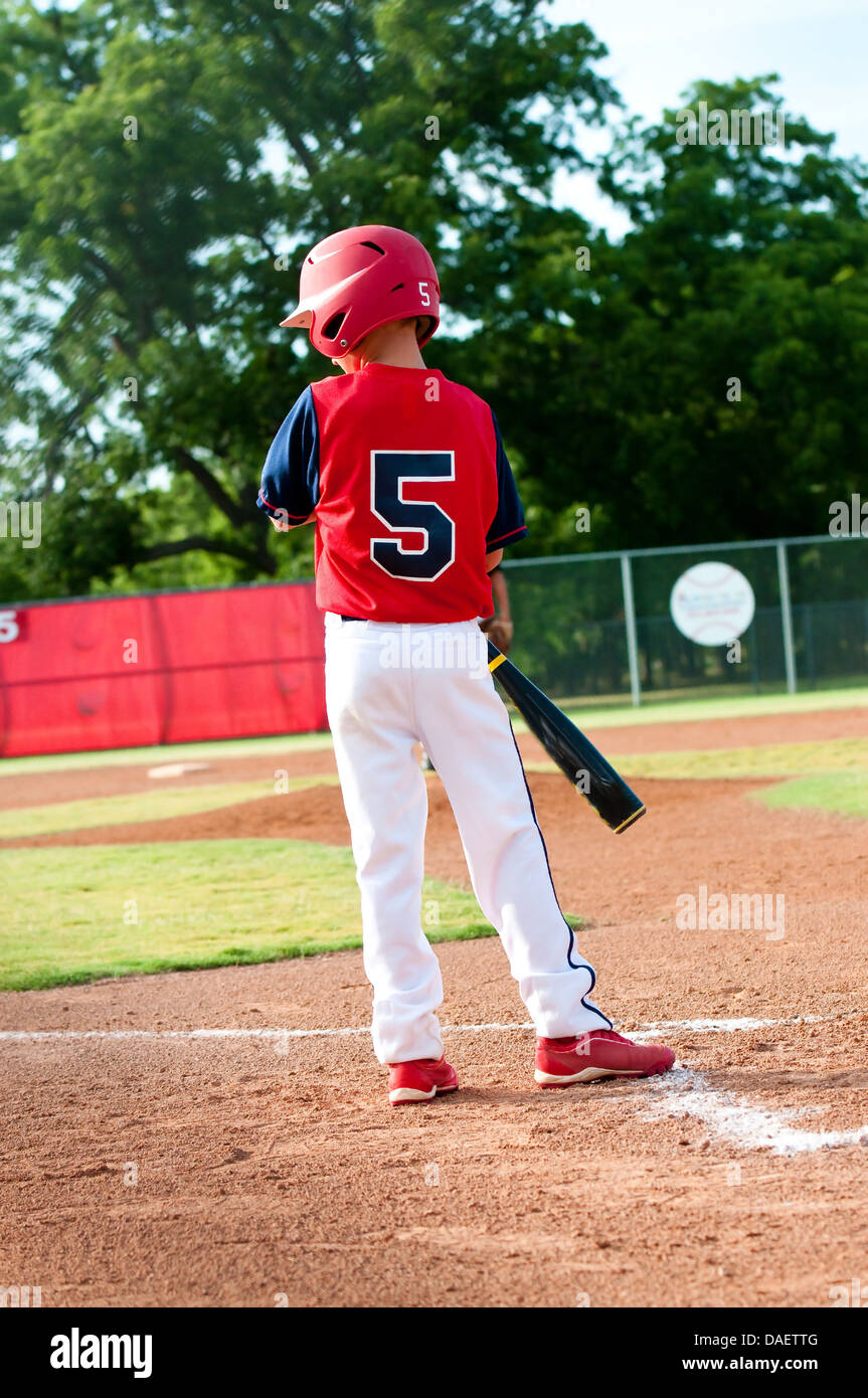 Little league boy getting the sign from the coach before batting Stock