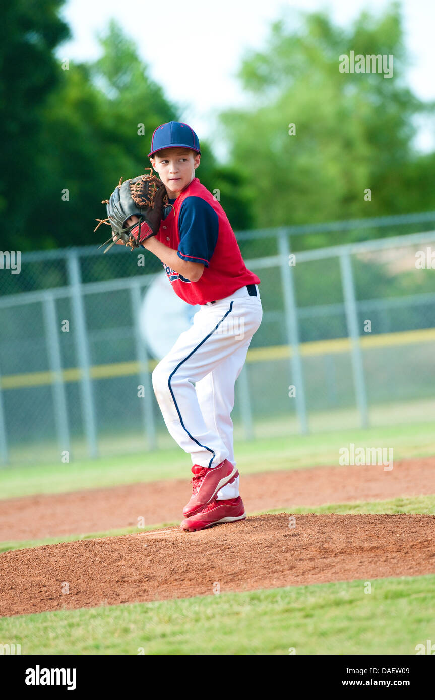 Little league baseball boy pitching during a game. Stock Photo