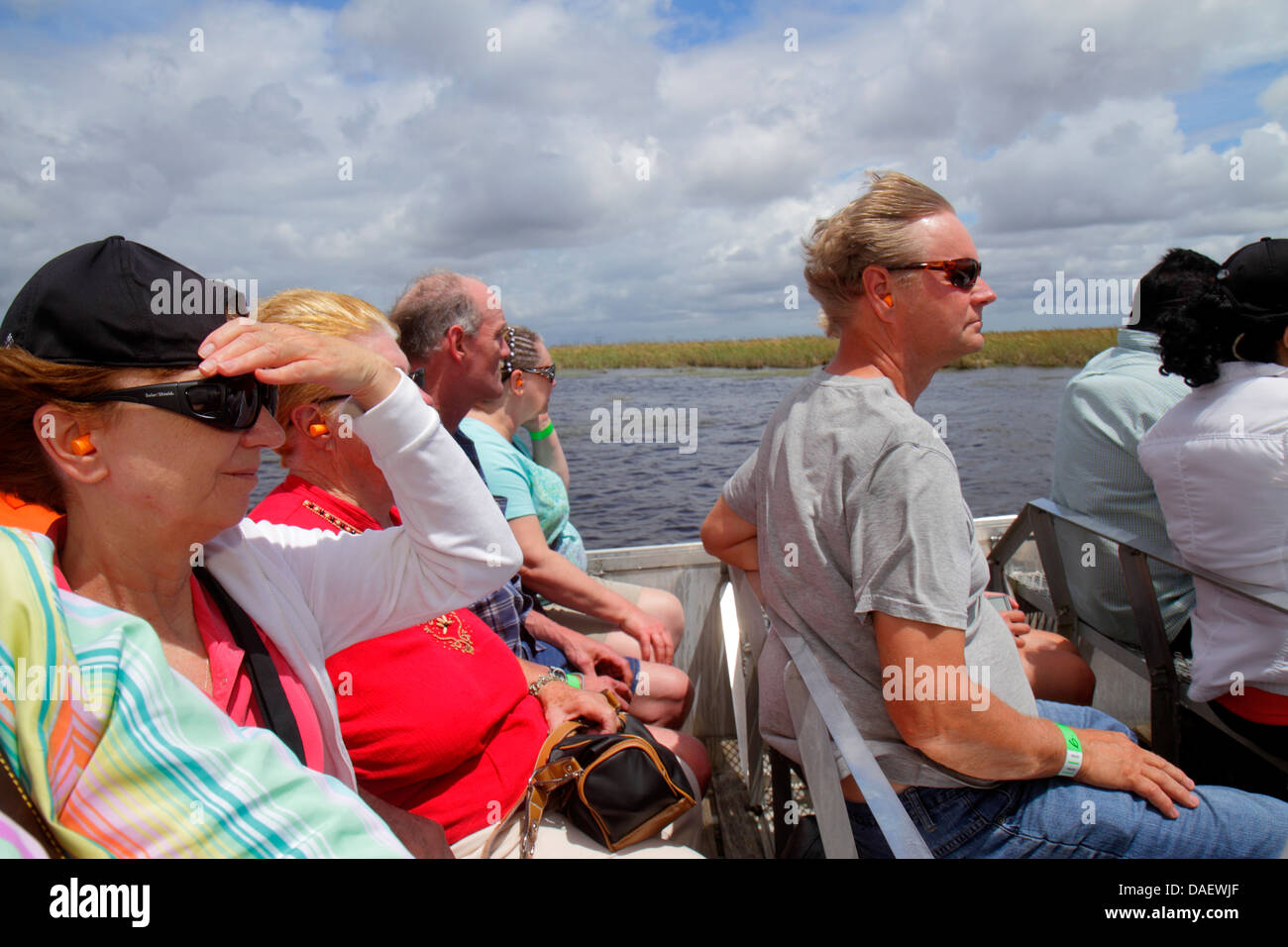 Fort Ft. Lauderdale Weston Florida,Fort Ft. Lauderdale,Sawgrass Recreation Park,Everglades,riders airboat ride,wind,holding onto hat,adult adults woma Stock Photo