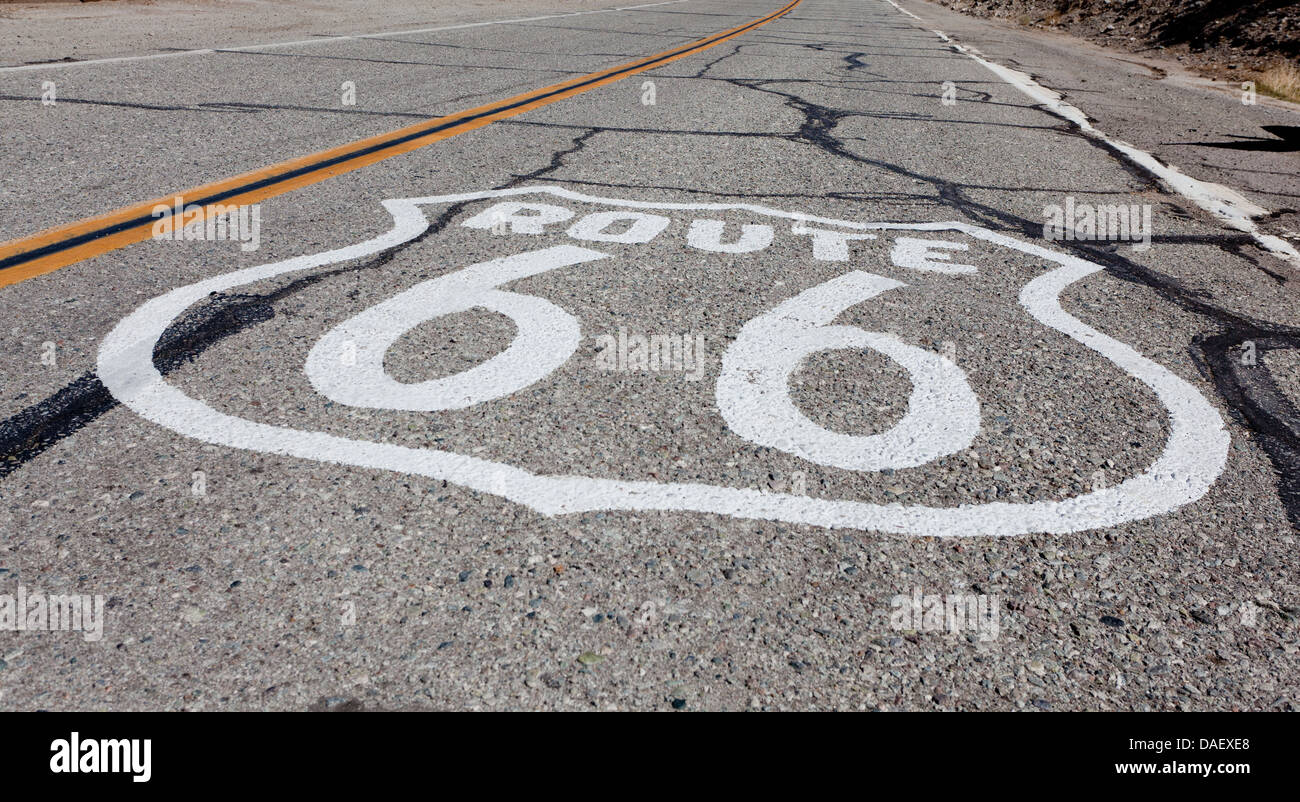 An old route 66 highway shield painted on old highway in California or Arizona Stock Photo