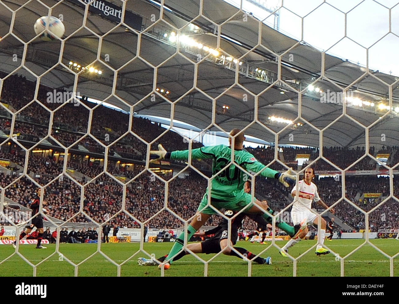 Fußball Bundesliga 13. Spieltag: VfB Augsburg goal keeper Mohammed Amsif cannot prevent the 1-0 goal by Stuttgart's Martin Harnik (R) during the German Bundesliga first division soccer match between VfB Stuttgart and FC Augsburg at the Mercedes-Benz Arena in Stuttgart, Germany, 20 November 2011. Stuttgart wins the match 2-1. Photo: Bernd Weissbrod  (ATTENTION: EMBARGO CONDITIONS! T Stock Photo
